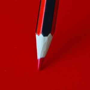 red pencil on a red surface
